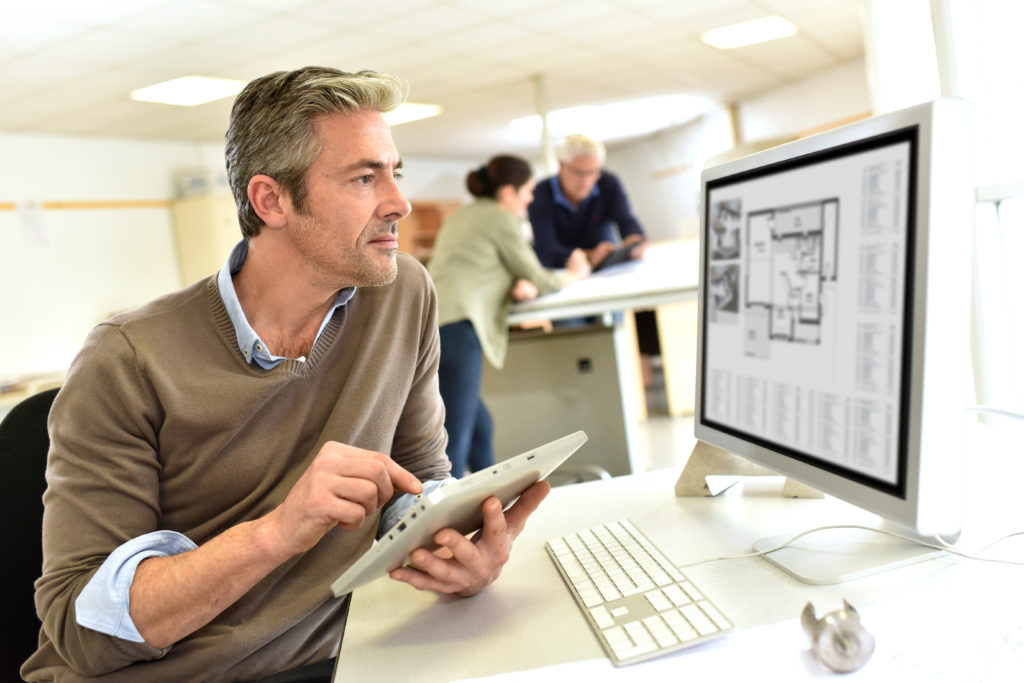 Engineer working in design office on desktop computer | Telecom ...